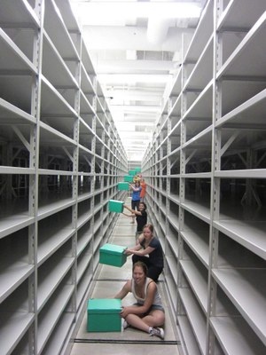 Field school students 2012 assisting with moving day, bringing the first collections into the repository at Sustainable Archaeology McMaster.